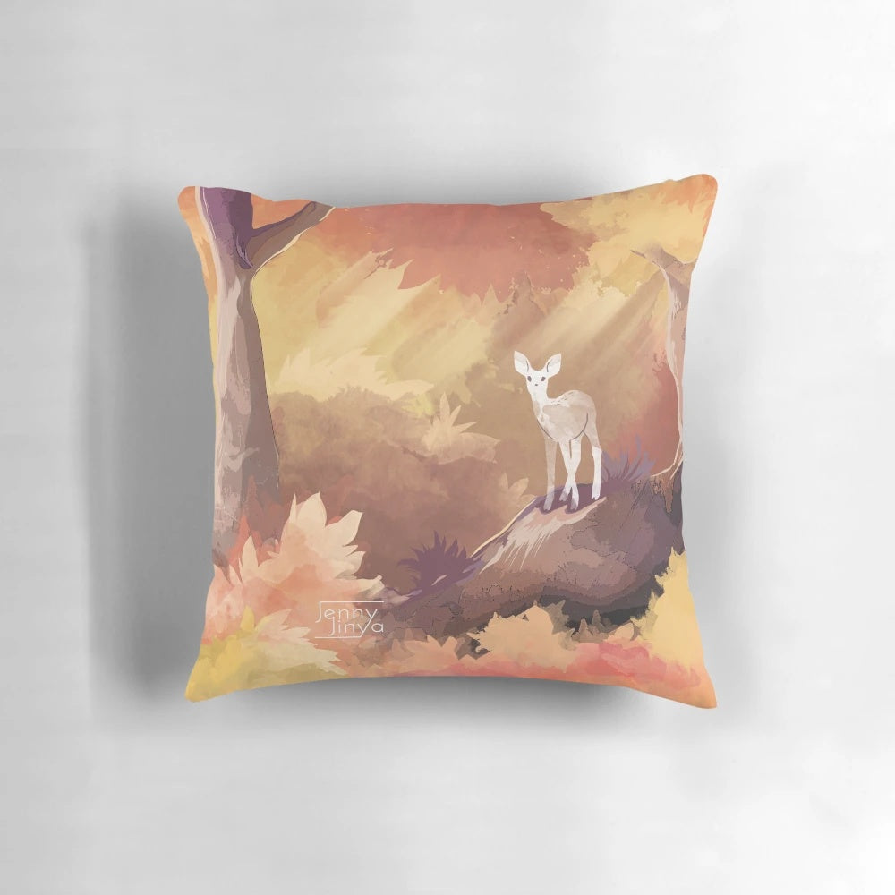 Autumn pillow featuring a watercolor design of a deer in a magical forest with fall leaves and sunrays
