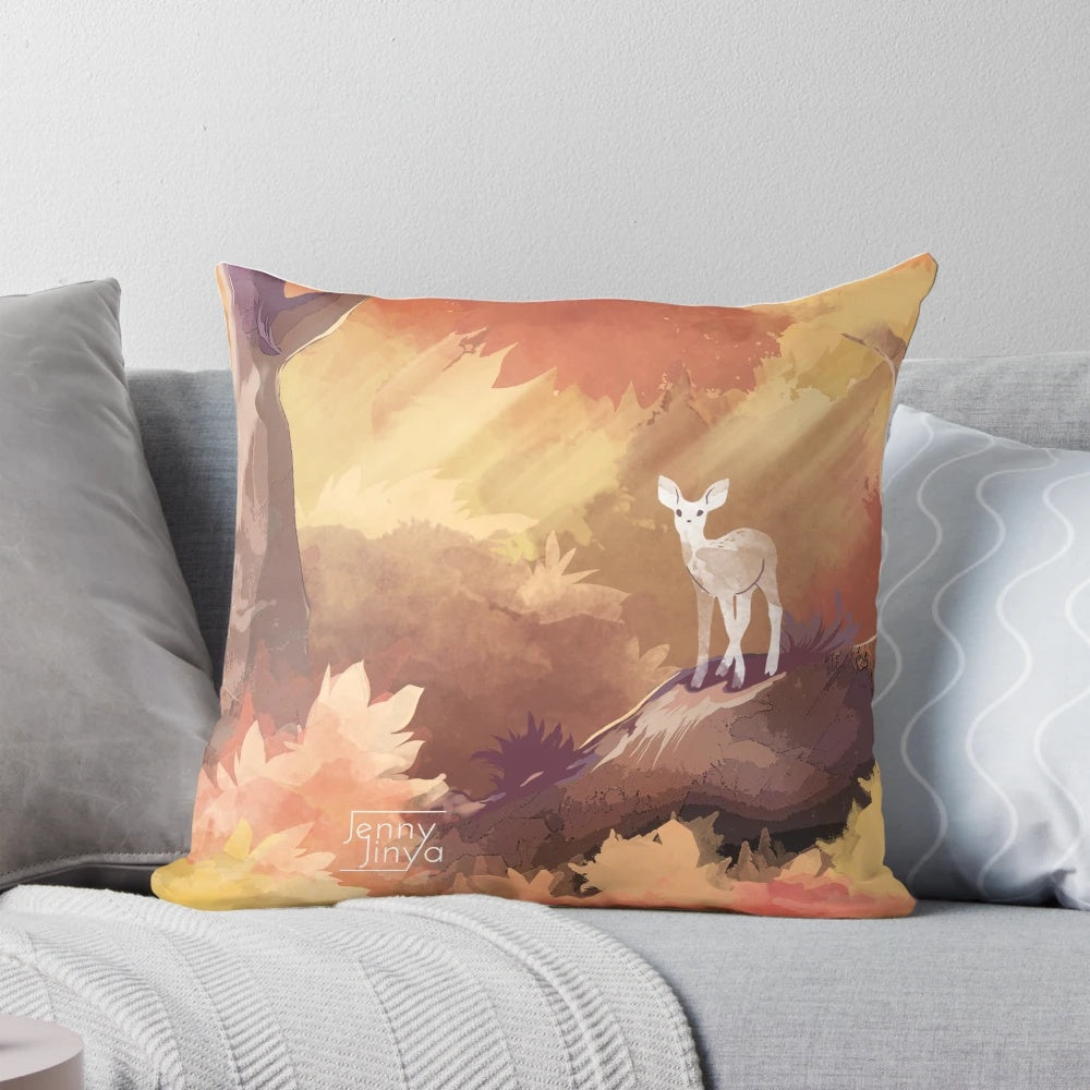 Autumn pillow featuring a watercolor design of a deer in a magical forest with fall leaves and sunrays