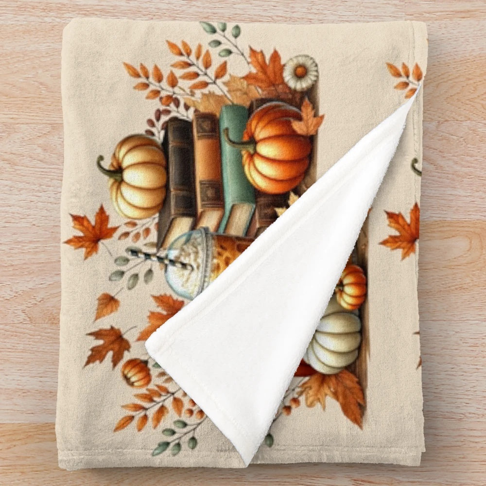 Cozy fall plush blanket with books, iced coffee, and pumpkins