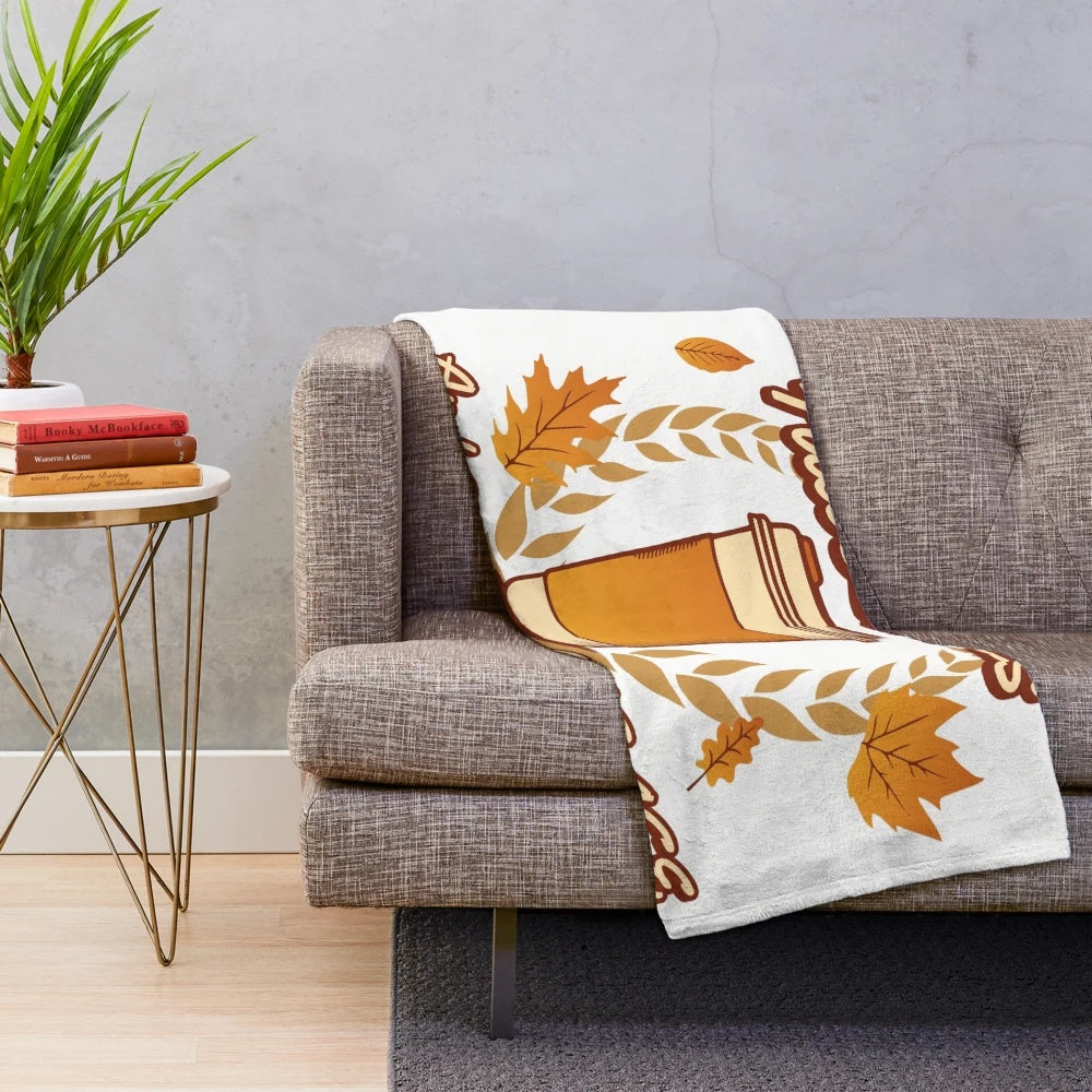 Plush blanket with fall leaves and coffee themed pattern