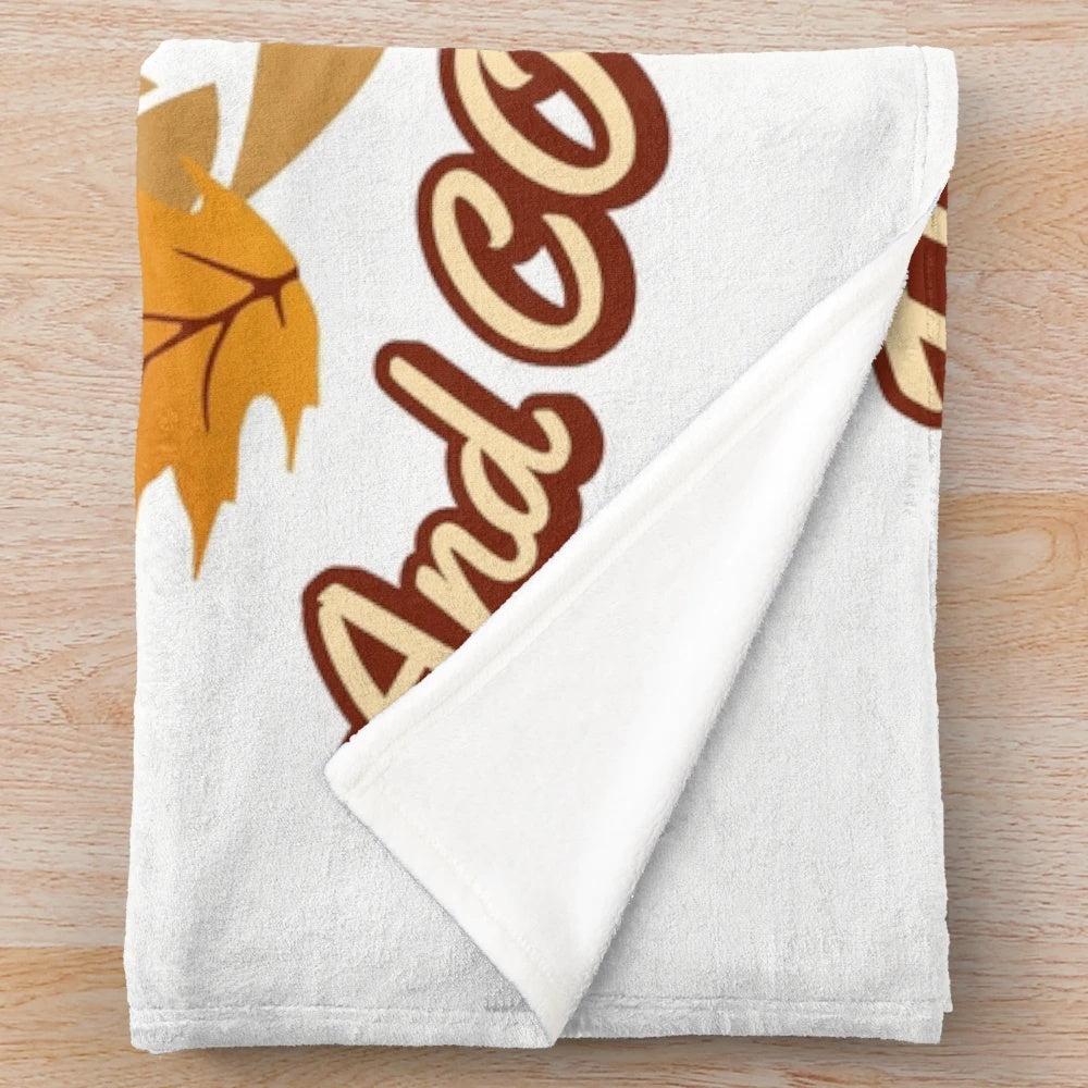 Plush blanket with fall leaves and coffee themed pattern