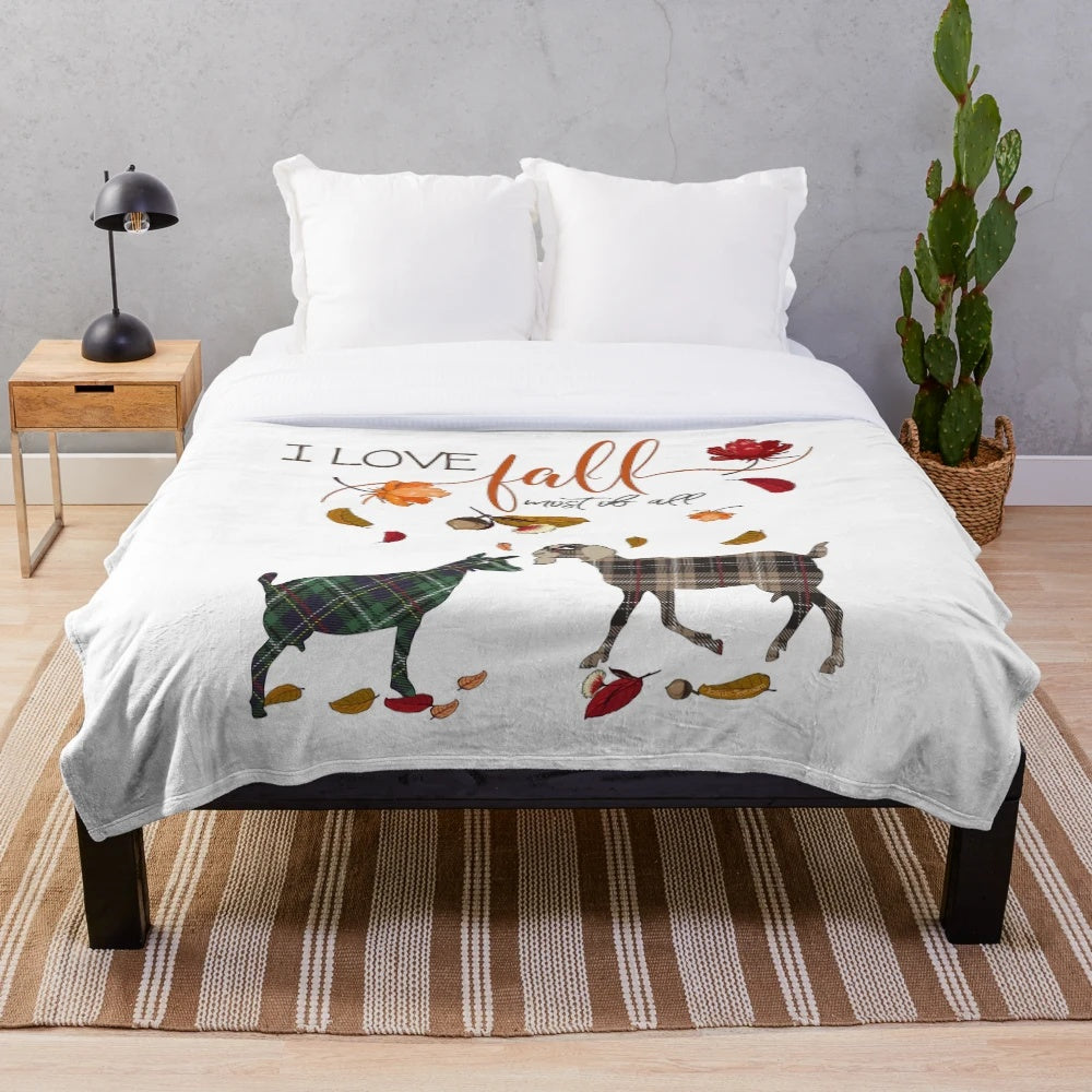 Plush blanket featuring a goat design and autumn leaves and acorns