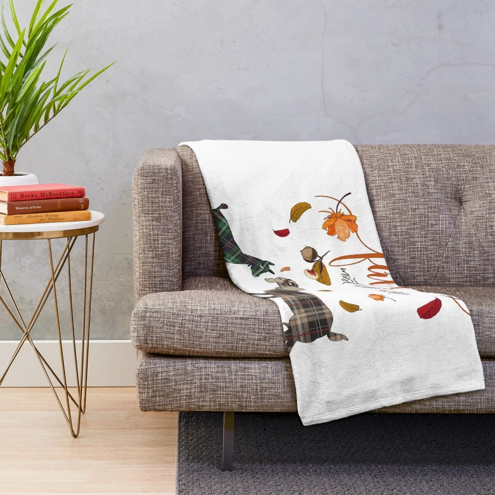 Plush blanket featuring a goat design and autumn leaves and acorns