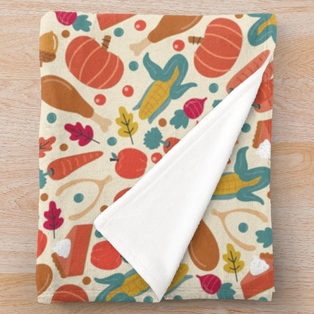 Thanksgiving-themed plush blanket with pumpkin pie, carrots, and autumn leaves
