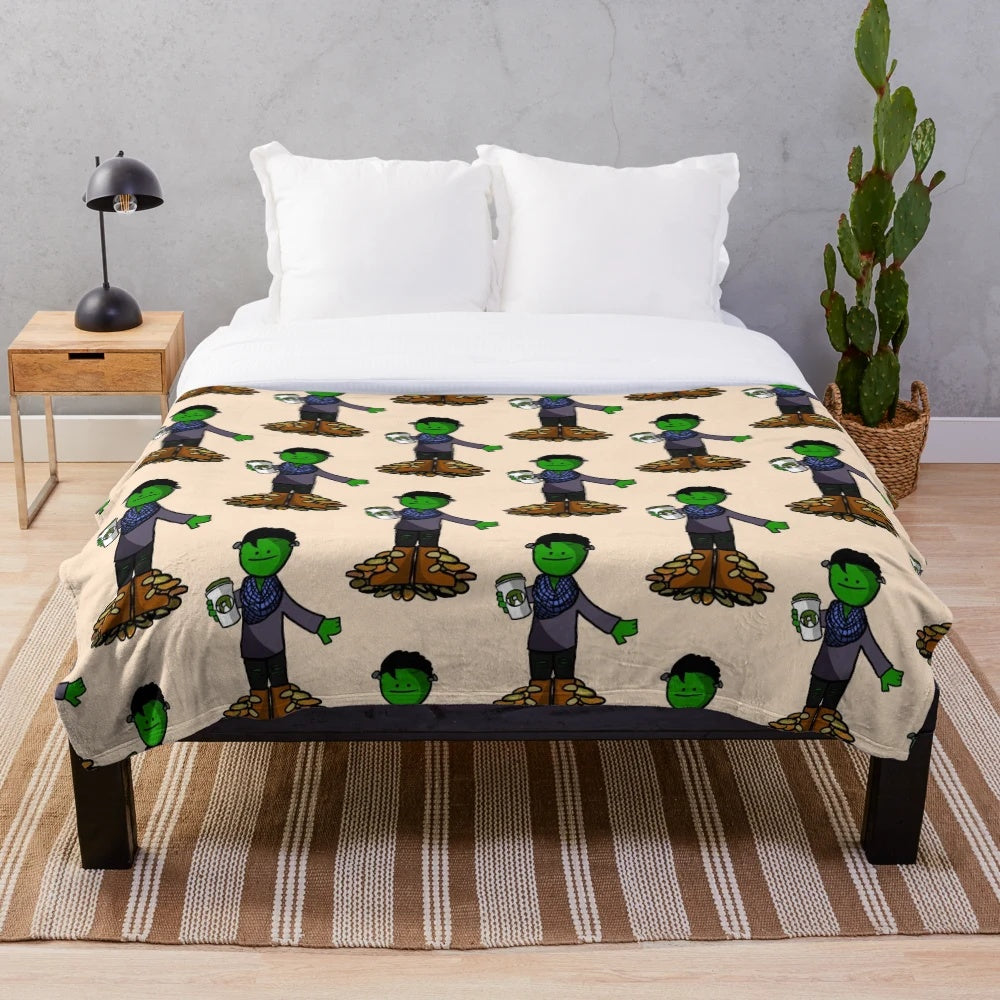 Plush green and orange blanket with monster and leaves design