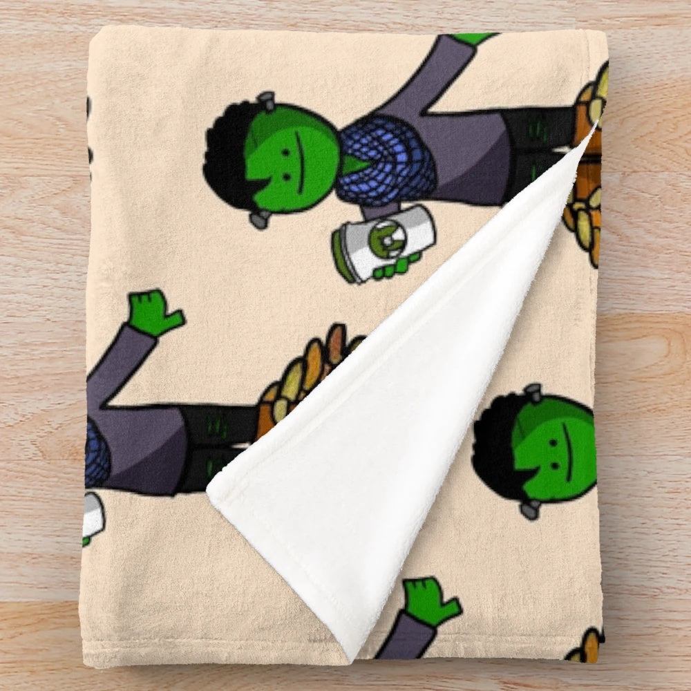 Plush green and orange blanket with monster and leaves design