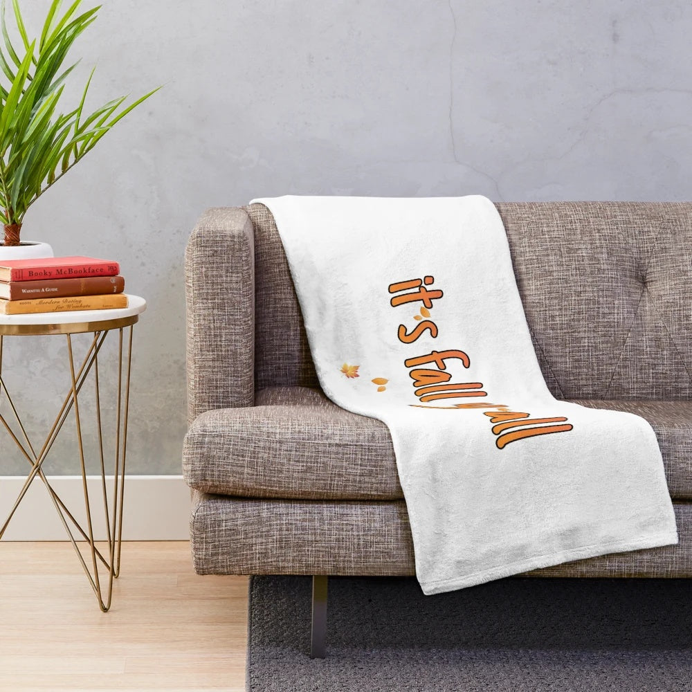 Plush blanket with autumn-inspired leaf and pumpkin pattern