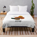 Plush blanket with minimalist autumn nature inspired design featuring leaves, trees, and floral patterns