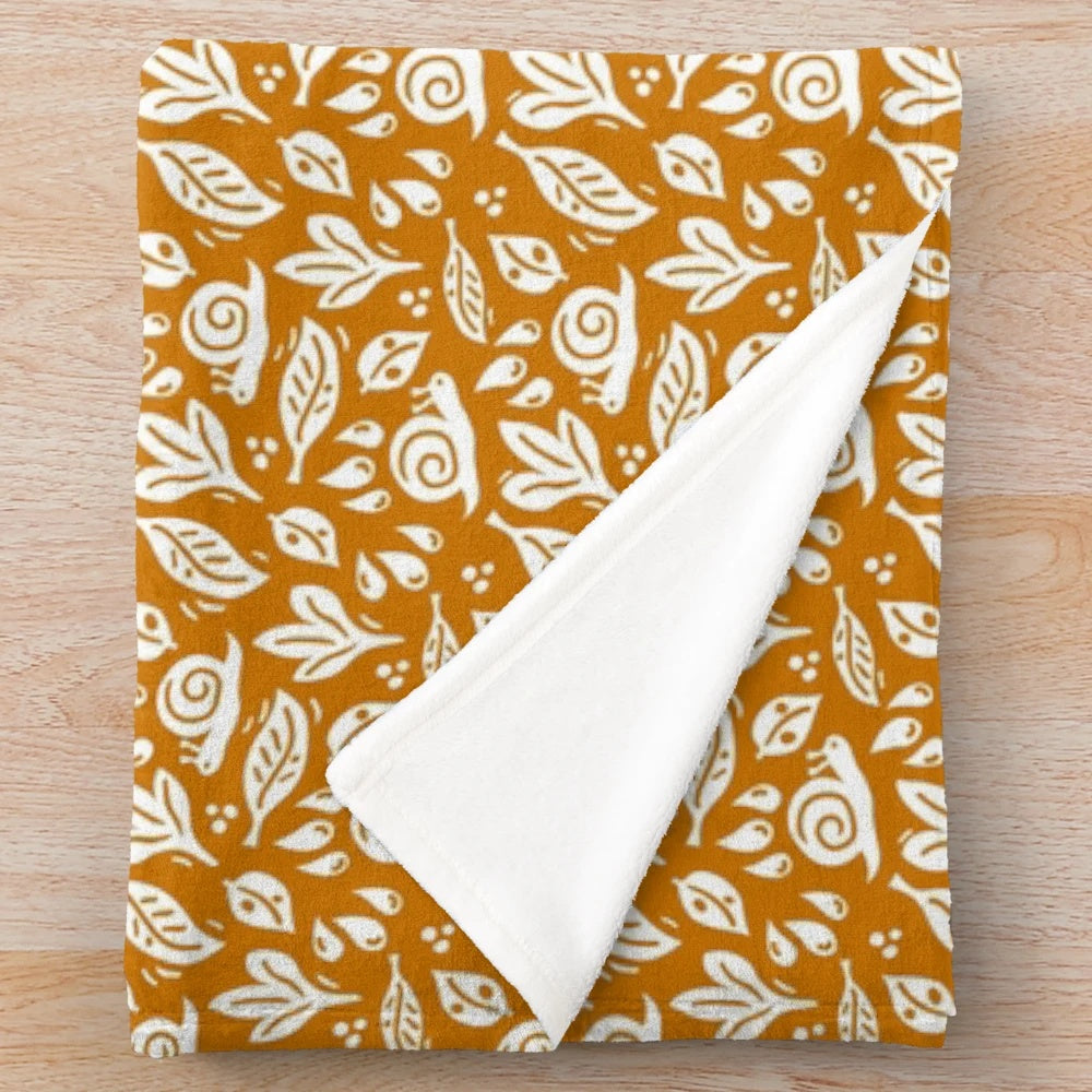 Cozy plush blanket with a nature-inspired snail and rain pattern for autumn decor