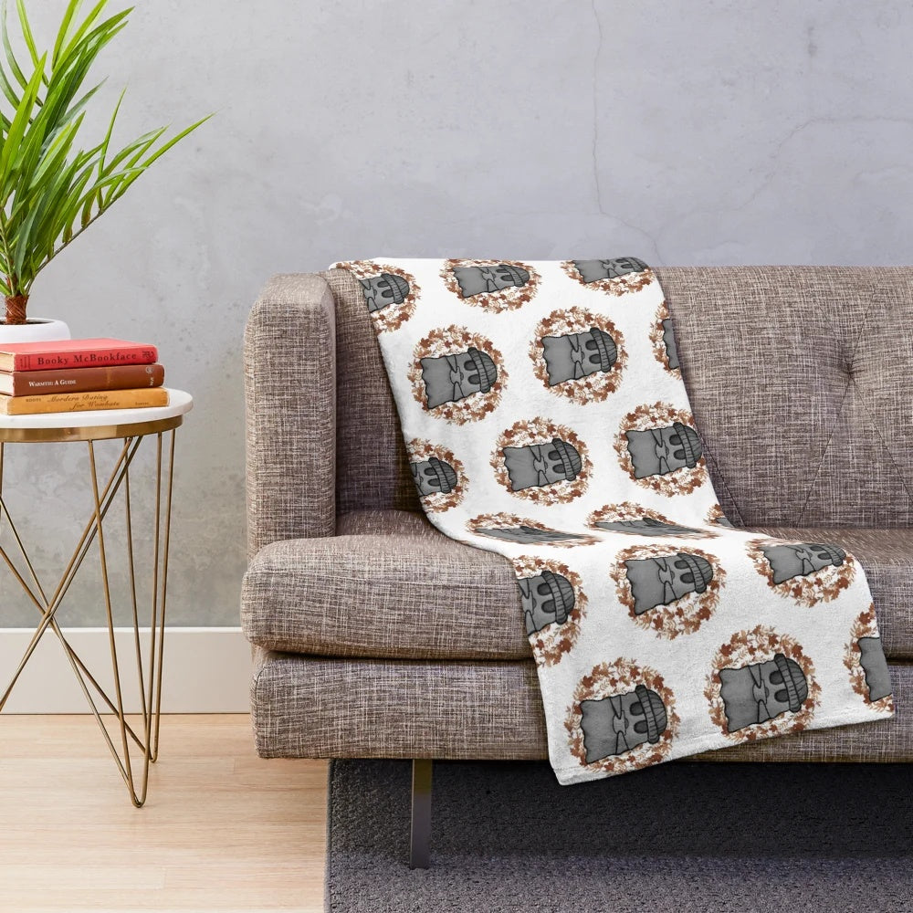 Cozy fall-themed plush blanket with ghostly and spooky elements