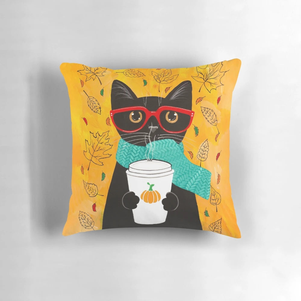 A cozy autumn-themed pillow featuring a cat wearing glasses and holding a pumpkin spice latte