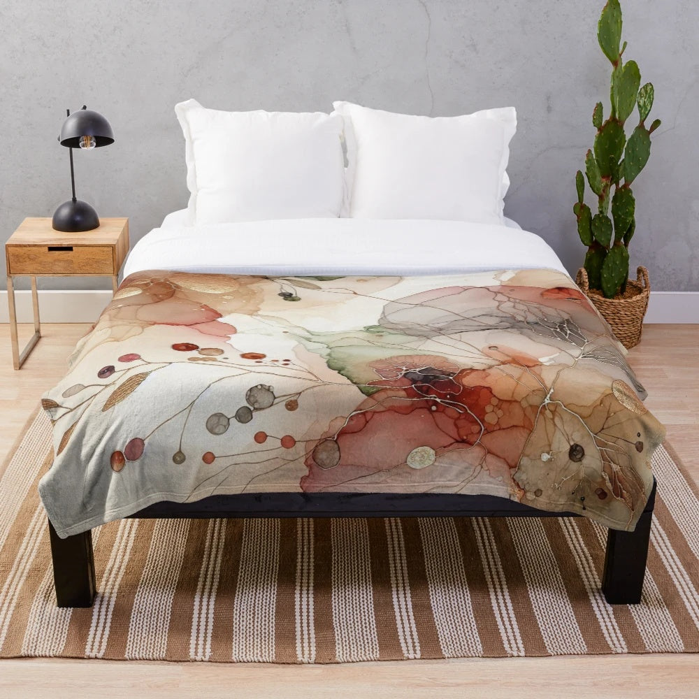 Cozy plush blanket with a watercolor abstract art design featuring autumn hues and nature elements