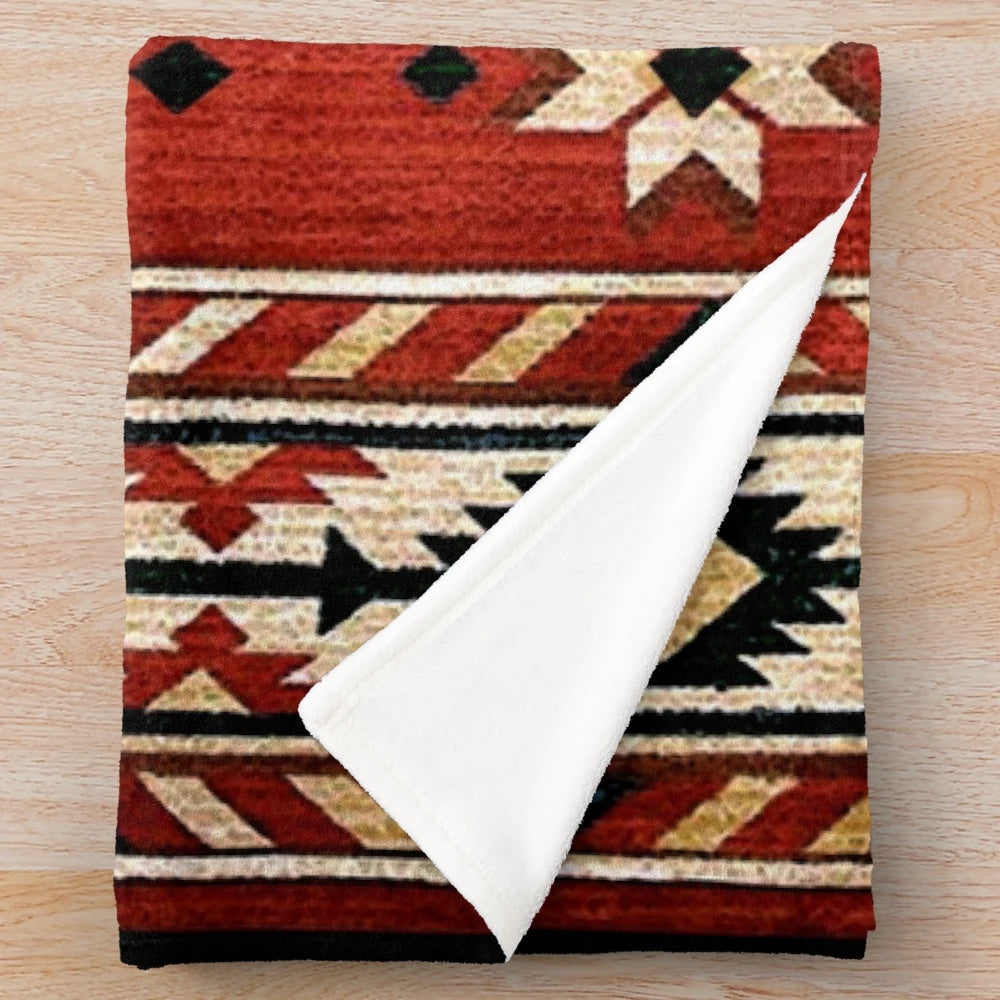 Aztec-patterned plush blanket in bright, bold colors