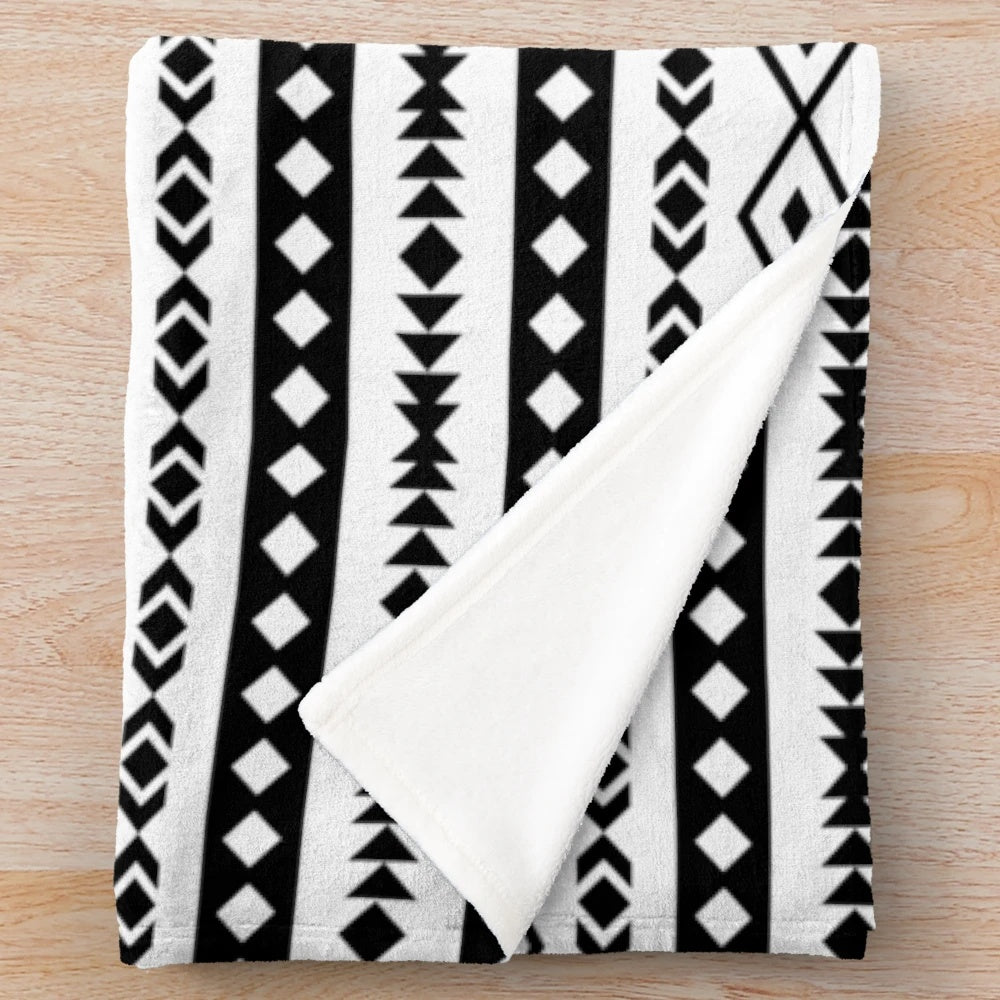Soft, plush blanket featuring an Aztec-inspired black and white tribal pattern design