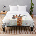 A soft and plush baby giraffe blanket featuring a watercolor painting