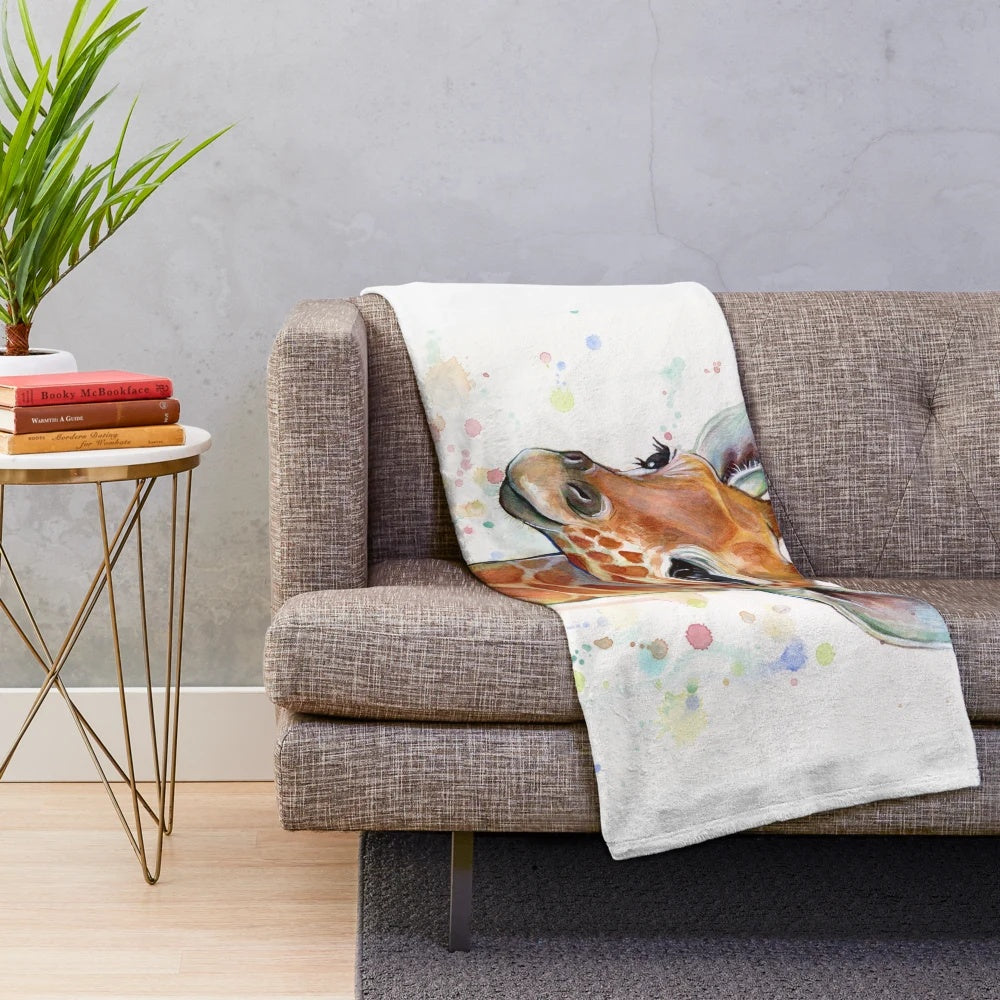 A soft and plush baby giraffe blanket featuring a watercolor painting
