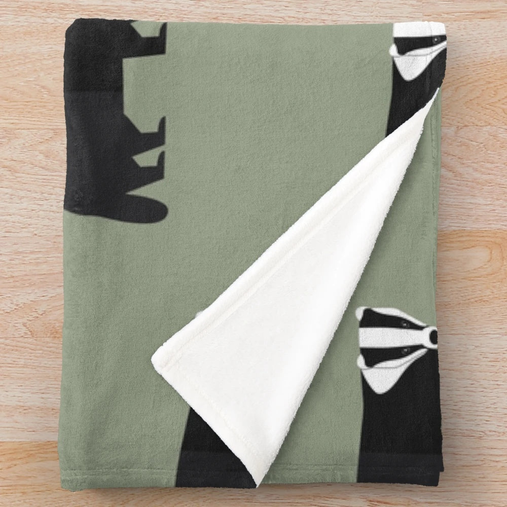 Plush blanket with a badger pattern in a forest-inspired design
