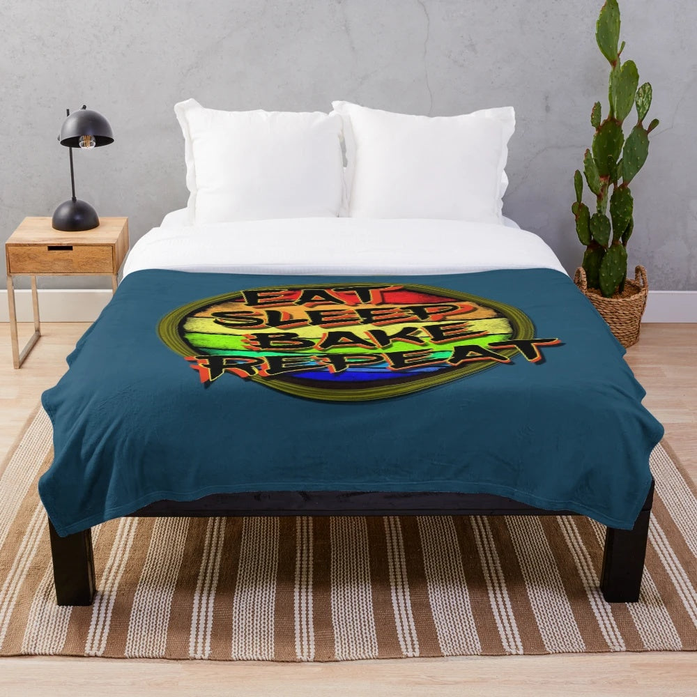 Soft and warm plush blanket featuring a "Eat Sleep Bake Repeat" design for baking enthusiasts