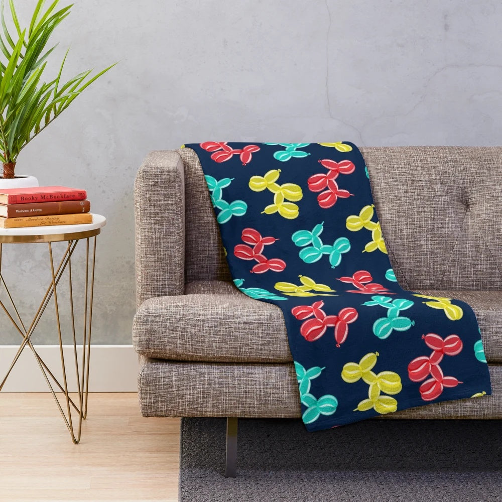 Soft and cuddly plush blanket with balloon dog design