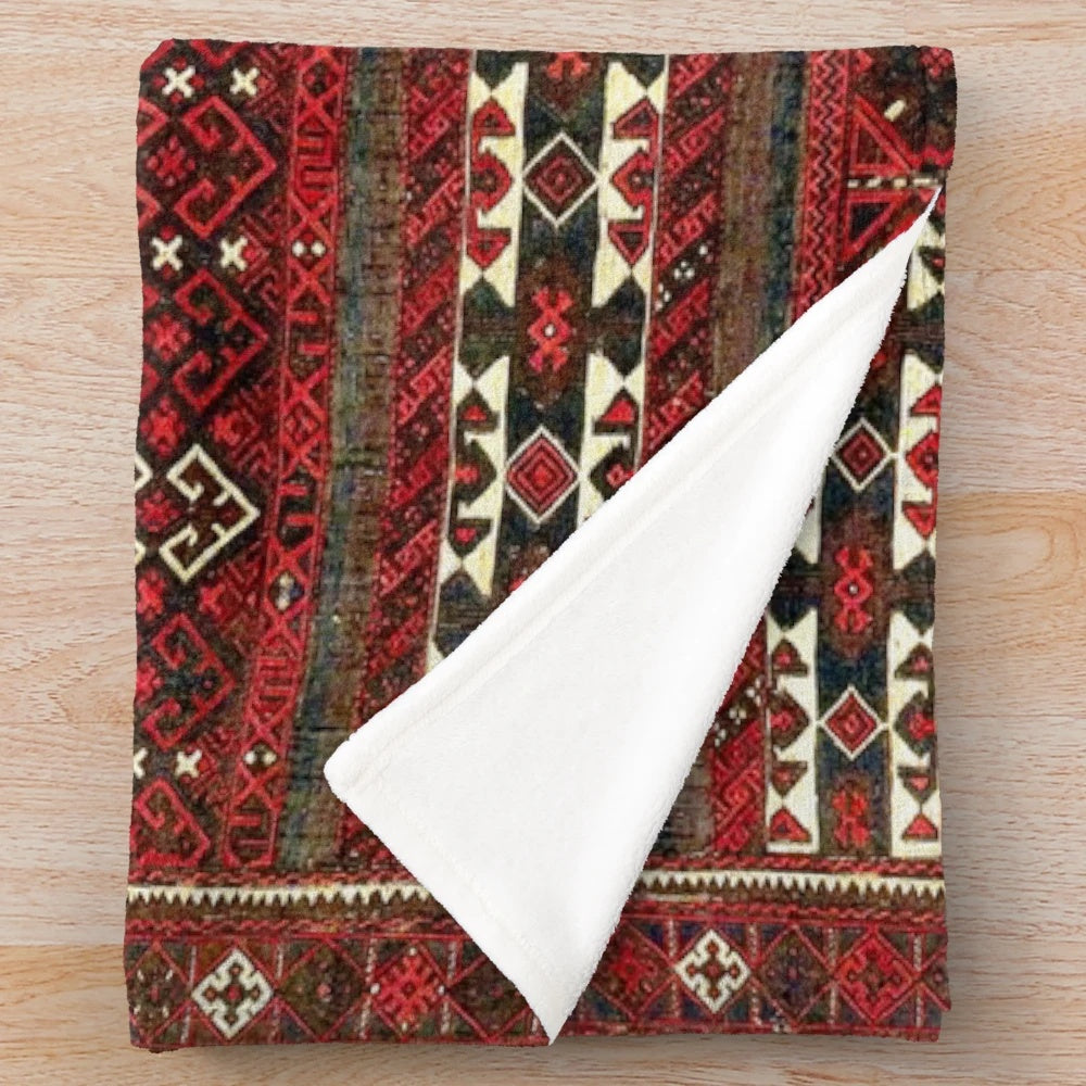 Antique-inspired plush blanket with Baluch flatweave rug design