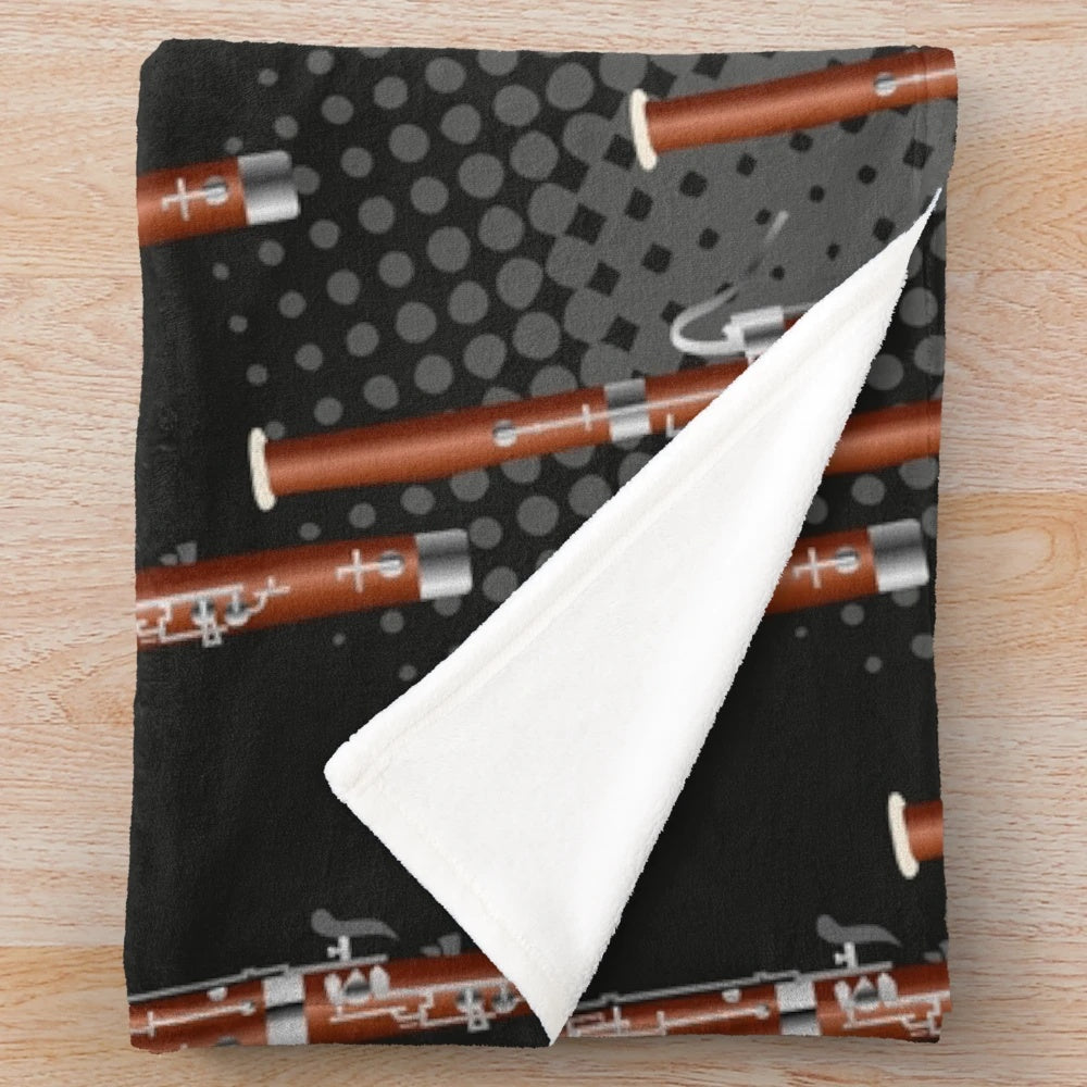 Cozy plush blanket with a bassoon design in black and gray