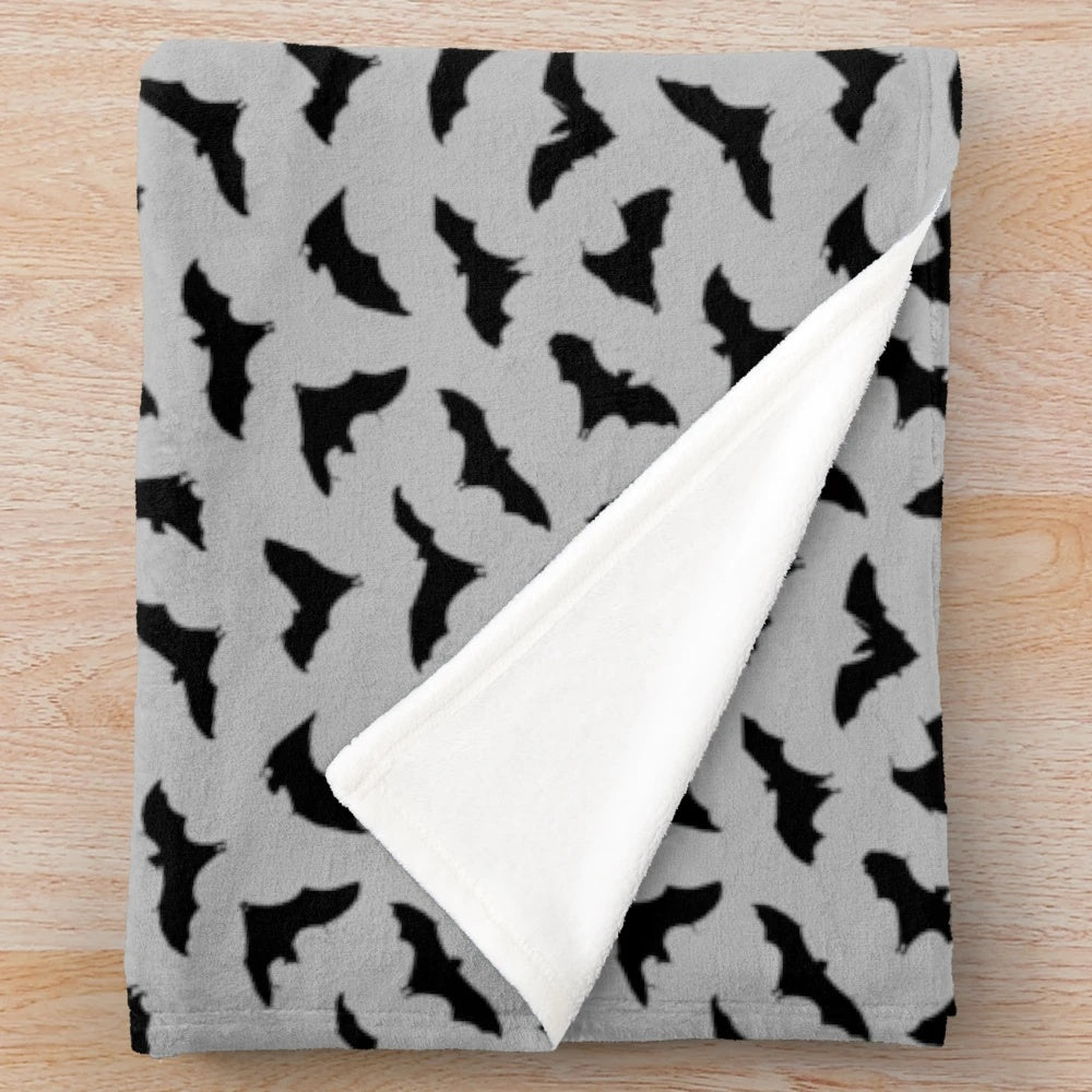 Plush grey blanket featuring a spooky bats design, perfect for Halloween and fall