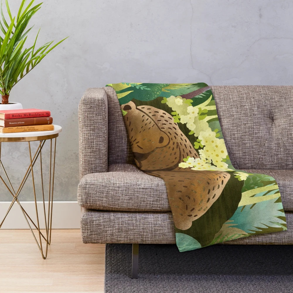 Soft and cuddly bear-themed plush blanket perfect for relaxing in nature