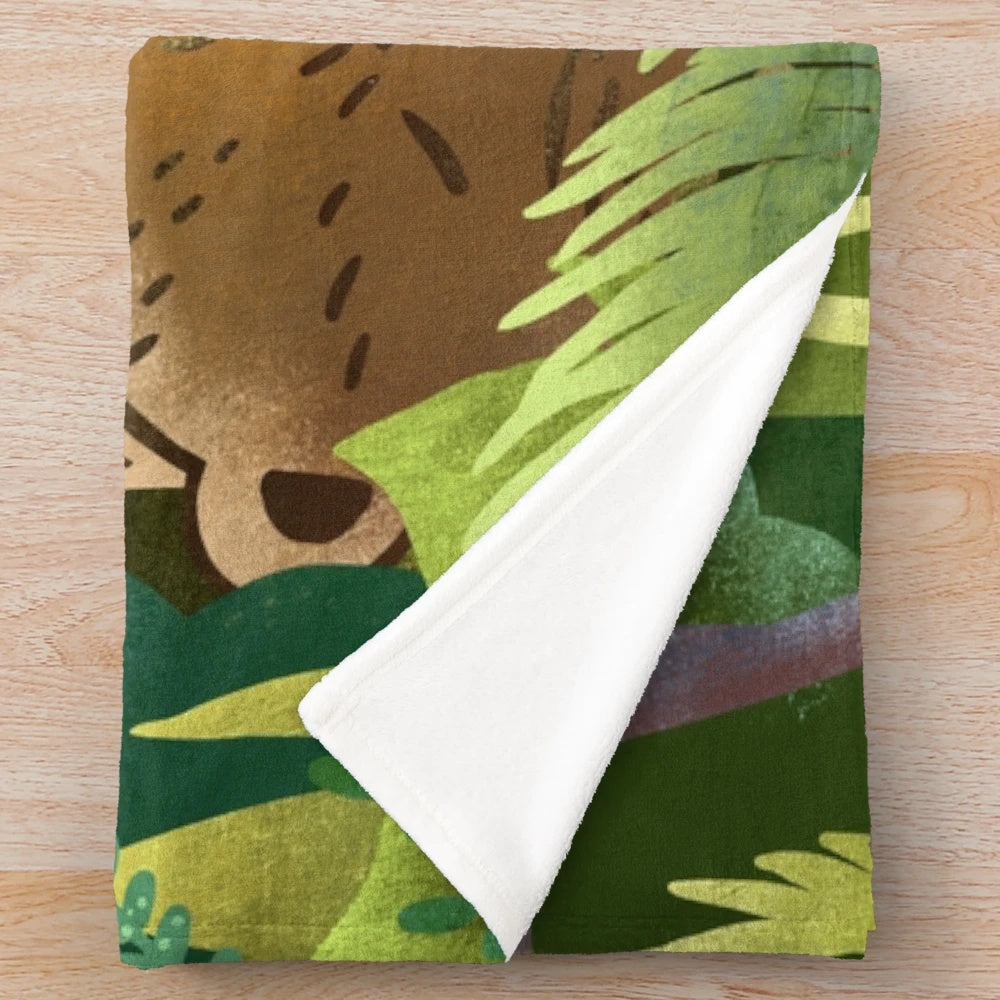 Soft and cuddly bear-themed plush blanket perfect for relaxing in nature