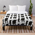 Belted Galloway cow plush blanket with soft, cozy texture