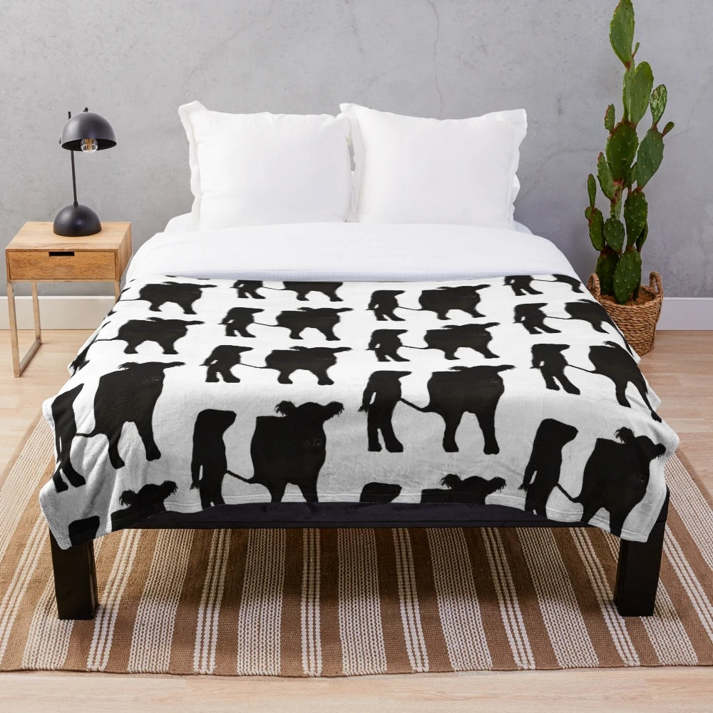 Belted Galloway cow plush blanket with soft, cozy texture