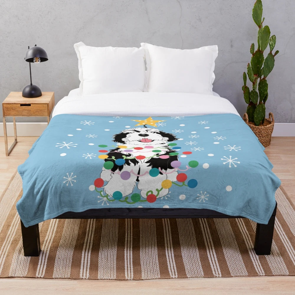 Soft and cuddly black and white bernedoodle plush blanket with a Christmas tree design