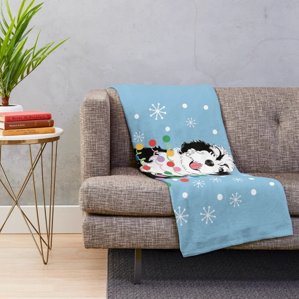 Soft and cuddly black and white bernedoodle plush blanket with a Christmas tree design