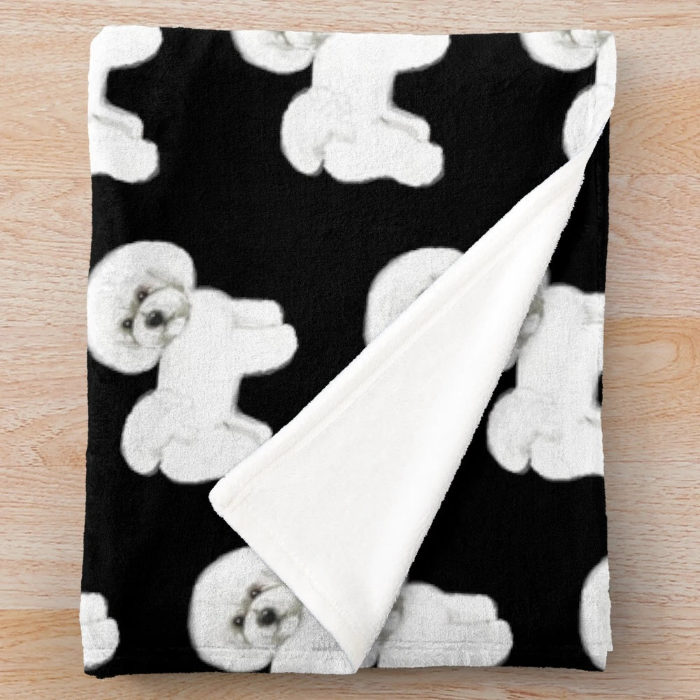 Bichon Frise dog on a plush white blanket