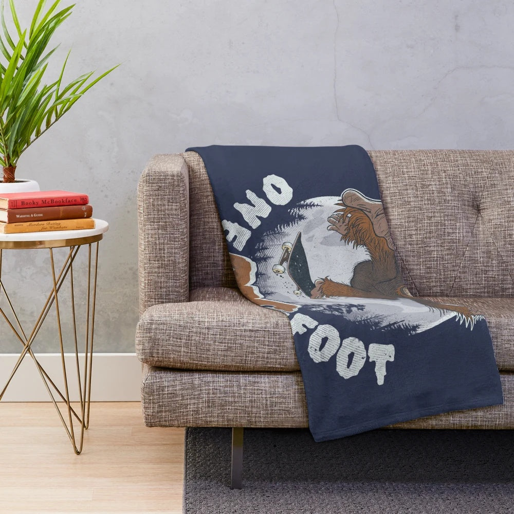Cozy plush blanket featuring a bigfoot or sasquatch design