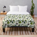 A plush blanket featuring a Bigfoot design, perfect for outdoor adventures and nature enthusiasts.