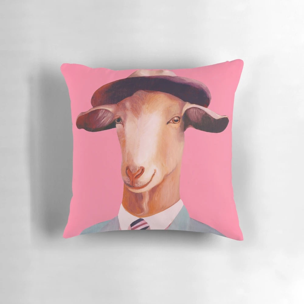 A soft, pink pillow featuring a detailed portrait of a billy goat, perfect for adding a touch of whimsy to any room.