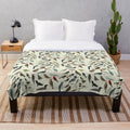 A soft and cuddly plush blanket featuring a variety of colorful bird species.