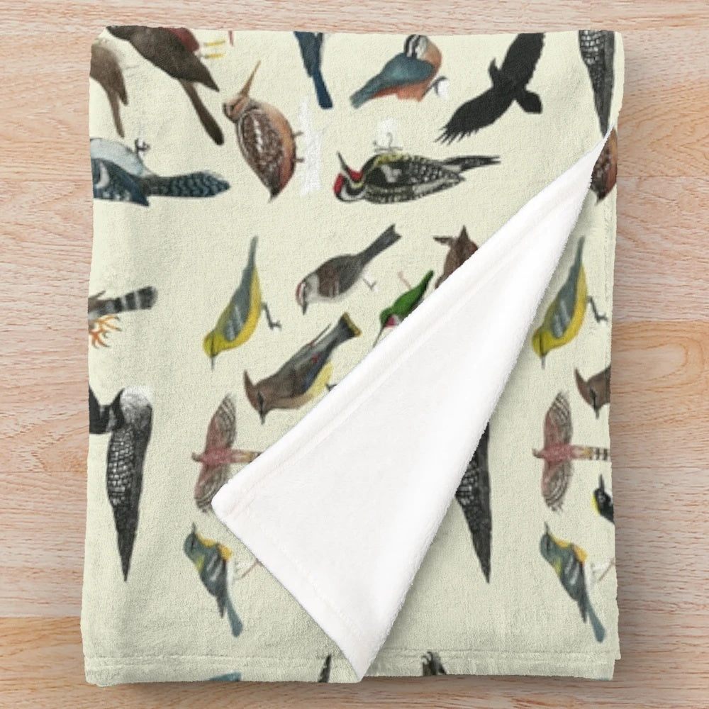 A soft and cuddly plush blanket featuring a variety of colorful bird species.