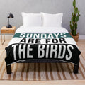 Plush blanket featuring birds and football imagery