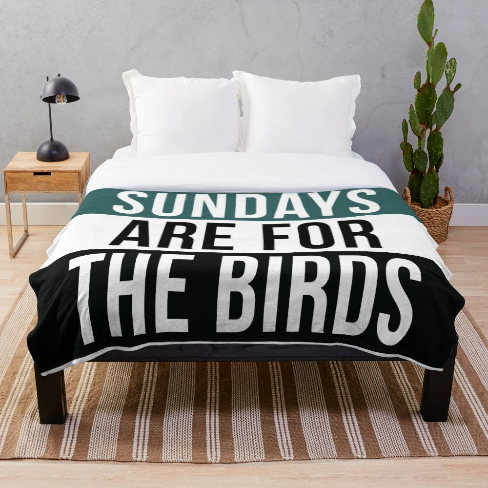 Plush blanket featuring birds and football imagery
