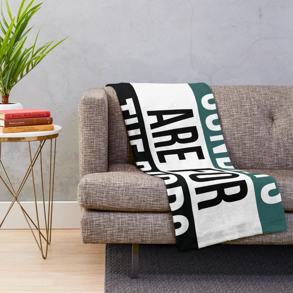 Plush blanket featuring birds and football imagery
