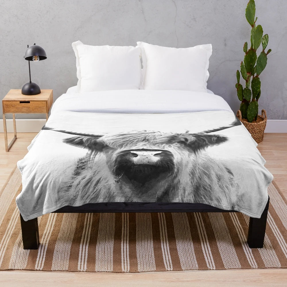 Soft and cuddly black and white highland cow plush blanket