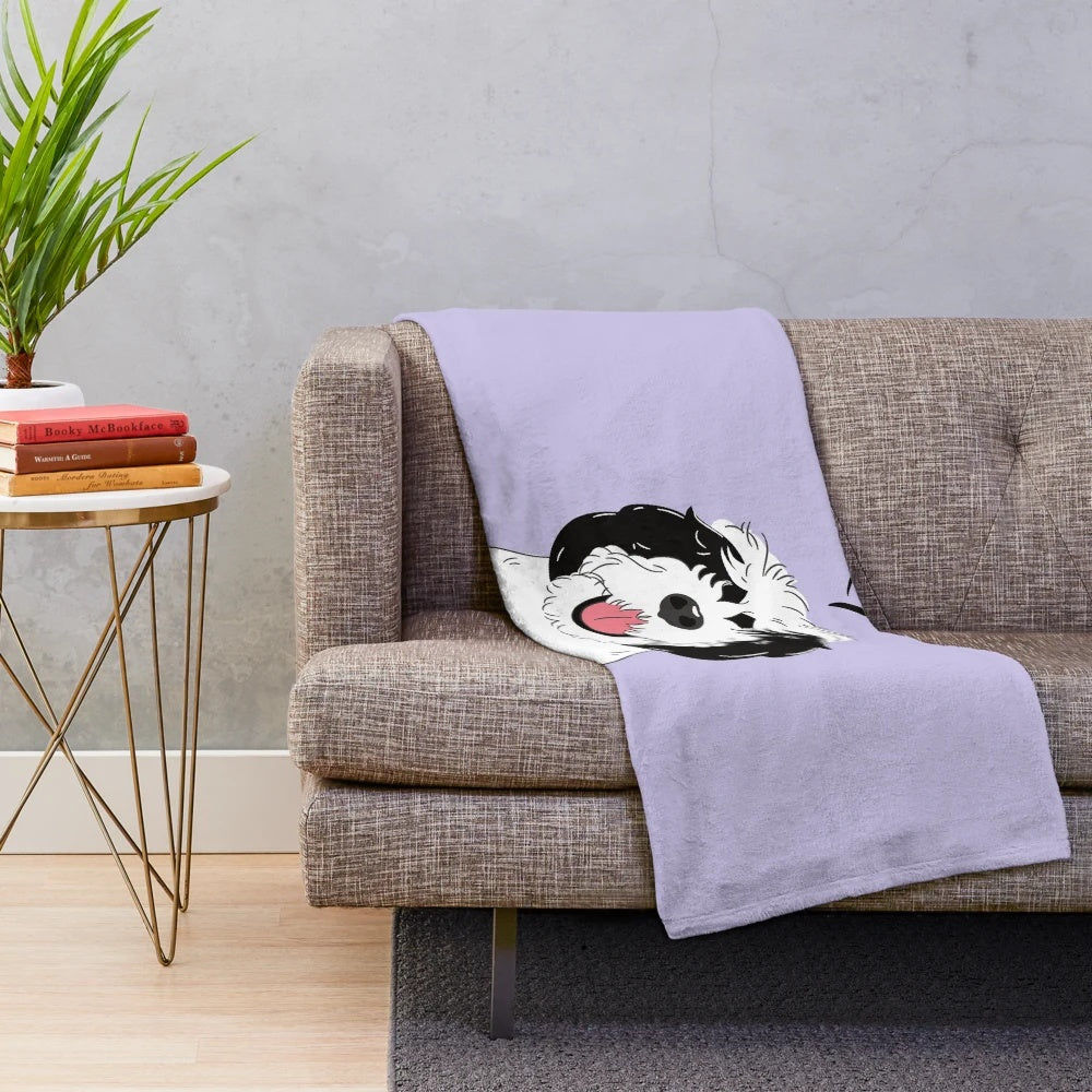 Black and white sheepadoodle dog printed on a soft lilac plush blanket