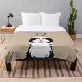 Black and white sheepadoodle dog on a plush blanket