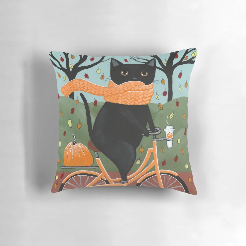 A black cat sitting on a bicycle against an autumn backdrop, perfect for a cozy home decor piece.
