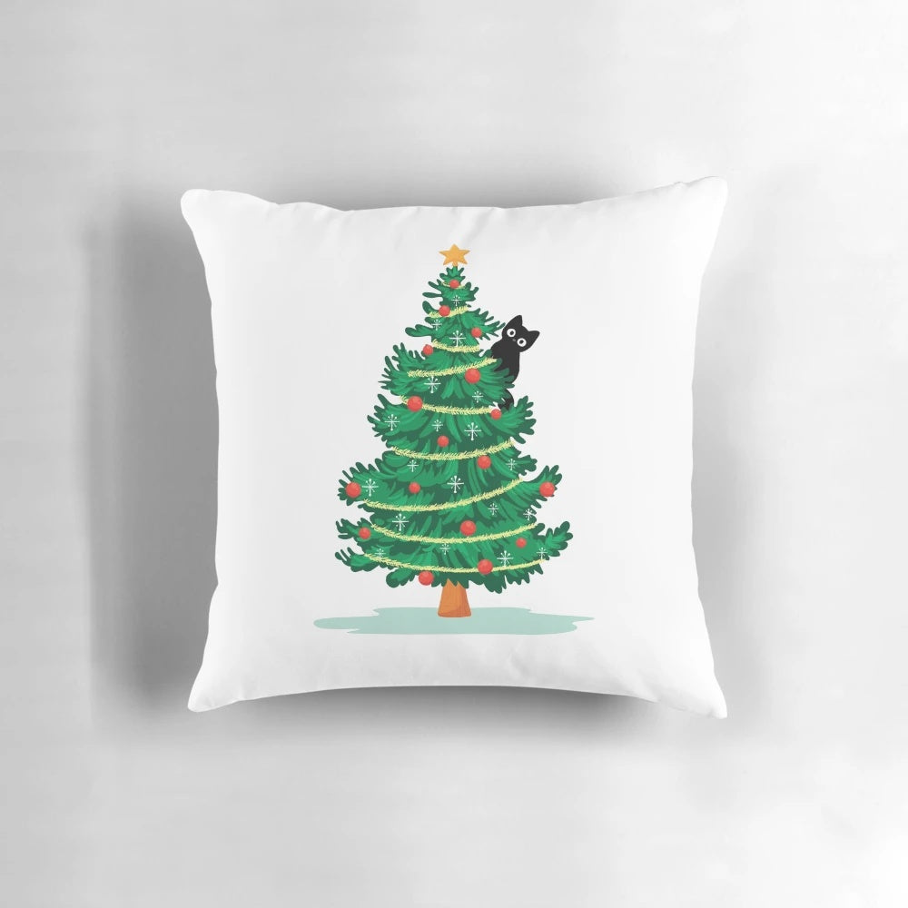 Soft, fluffy black cat nestled in a Christmas tree on a decorative pillow