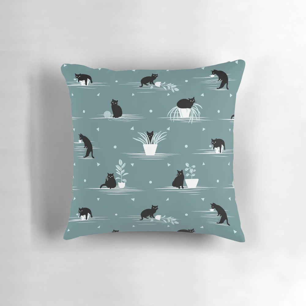 Decorative green and black cat print pillow with a cute feline design