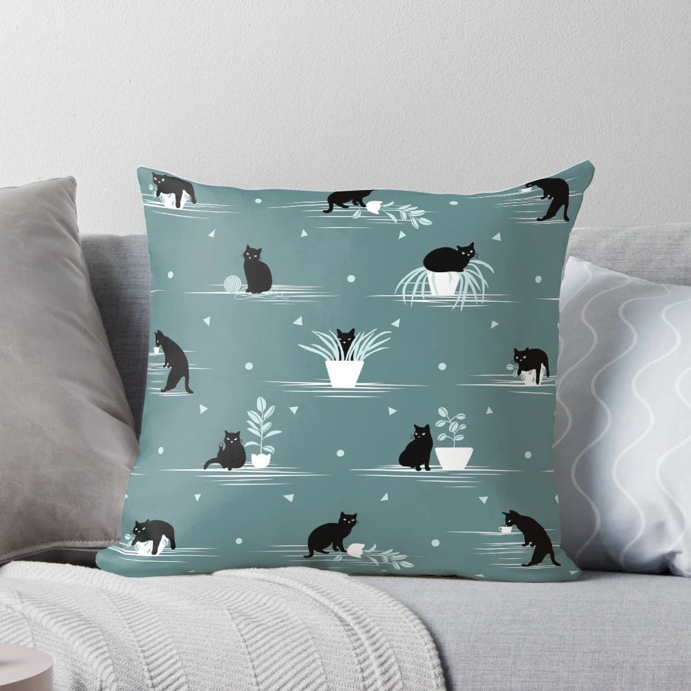 Decorative green and black cat print pillow with a cute feline design