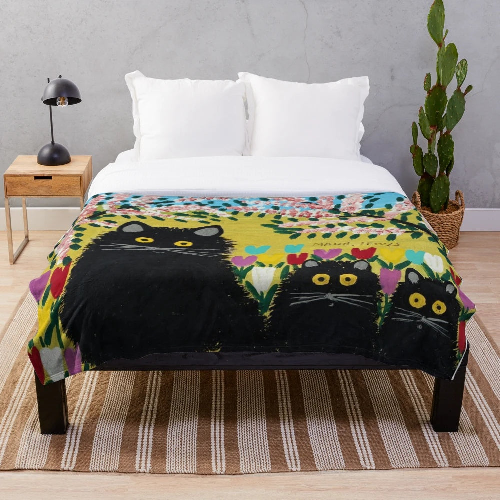 Plush black cat throw blanket featuring Maud Lewis inspired cat artwork