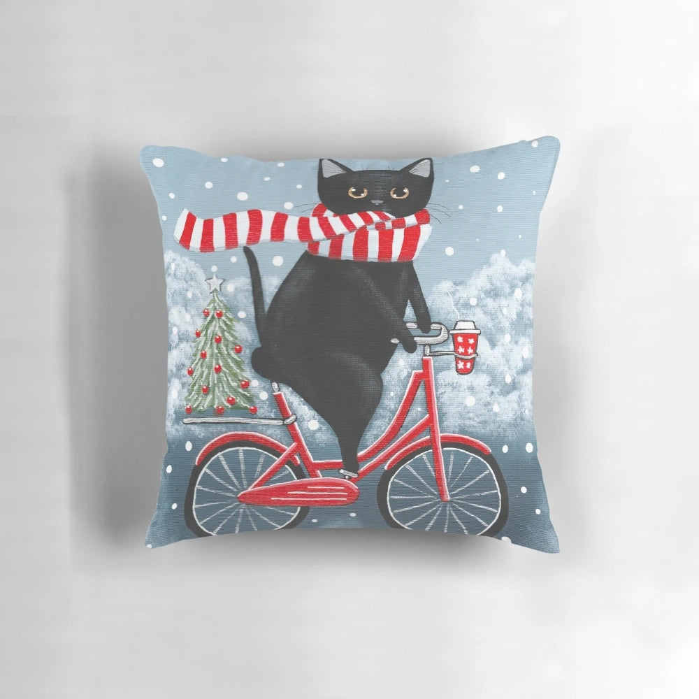 A black cat wearing a hat, riding a bicycle on a winter landscape with a Christmas tree.